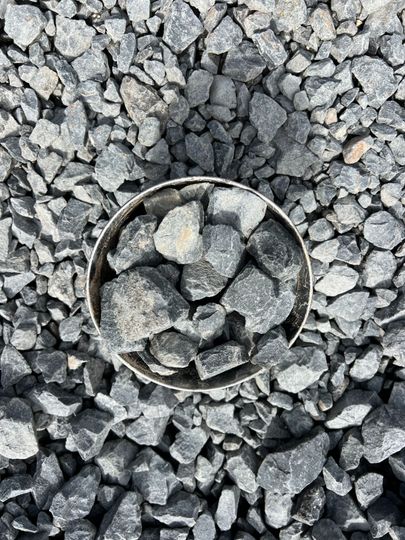 A pile of rocks sitting on top of a gravel road.