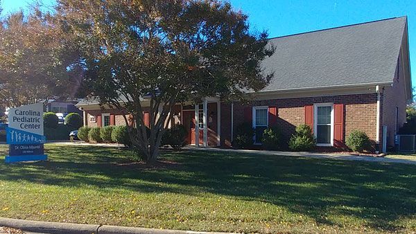 A brick building with with a sign in front of it that says 