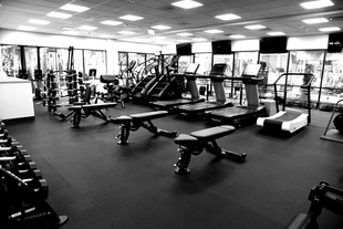 Woman doing leg press exercise at a gym.