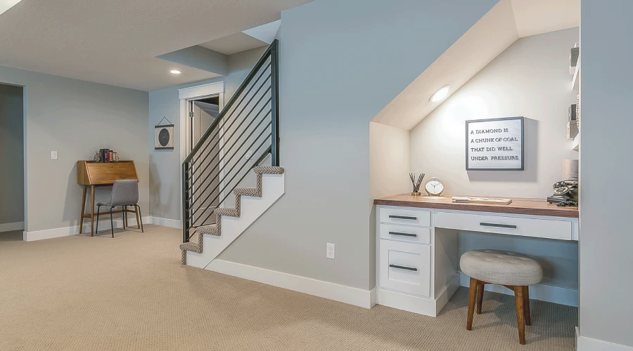 There is a desk under the stairs in the basement.