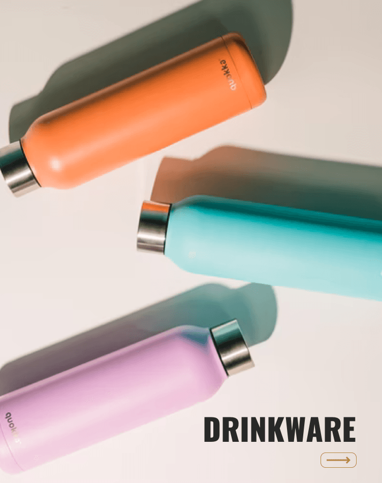 Three different colored drinkware bottles are on a table
