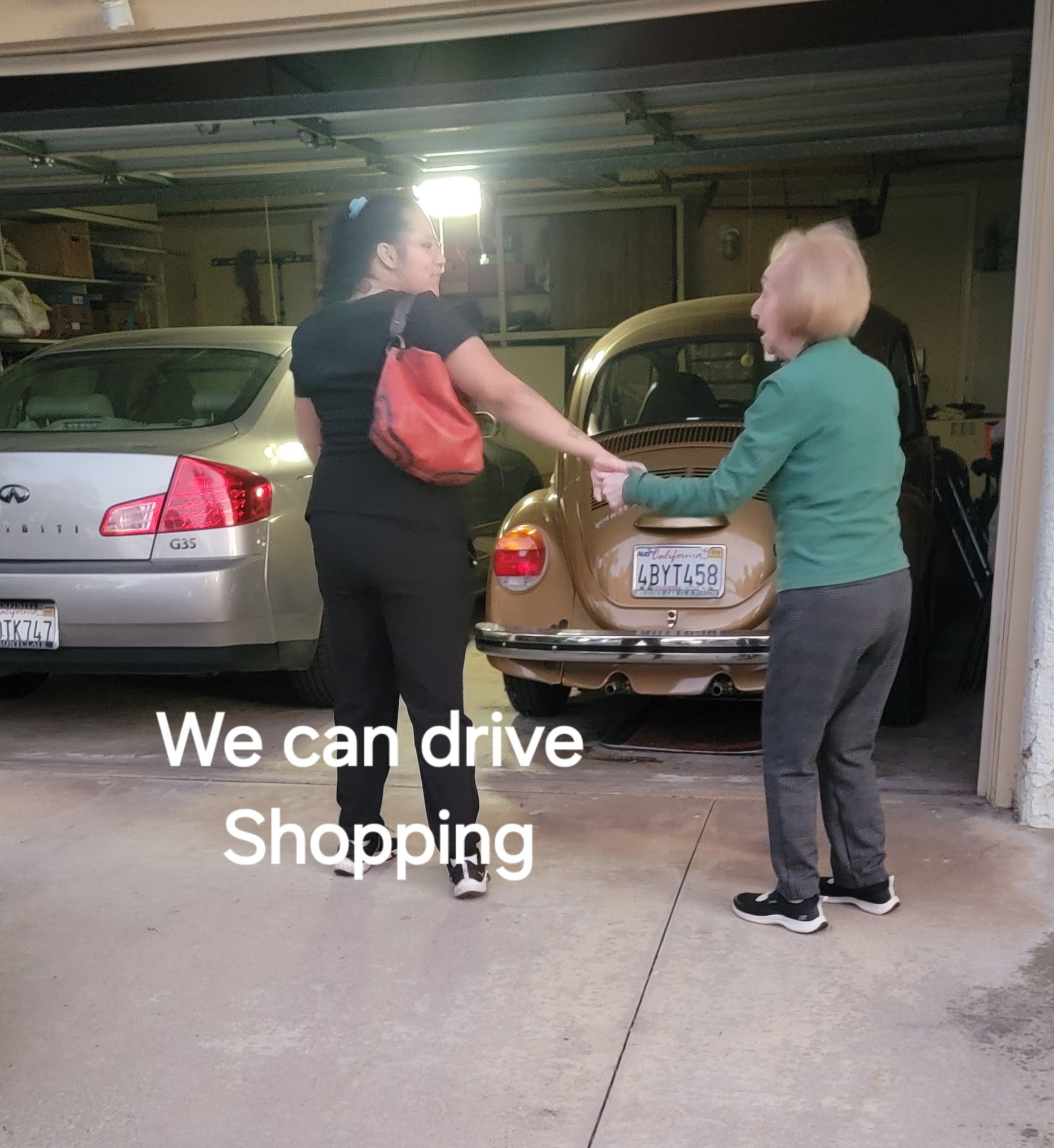 Two women are standing in front of a car that says we can drive shopping
