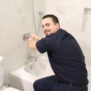 A plumber is fixing a faucet 