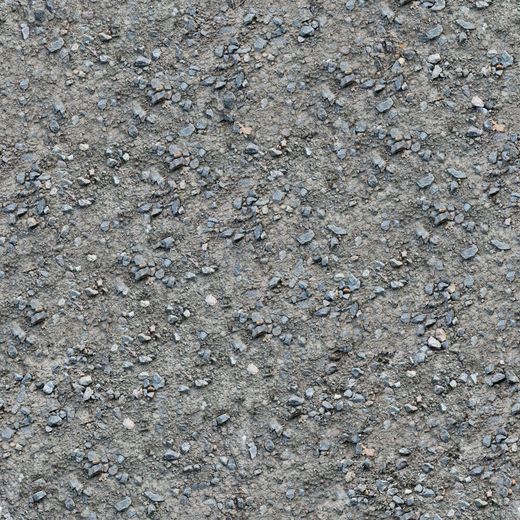 Gravel ground texture with small, gray stones and dirt.