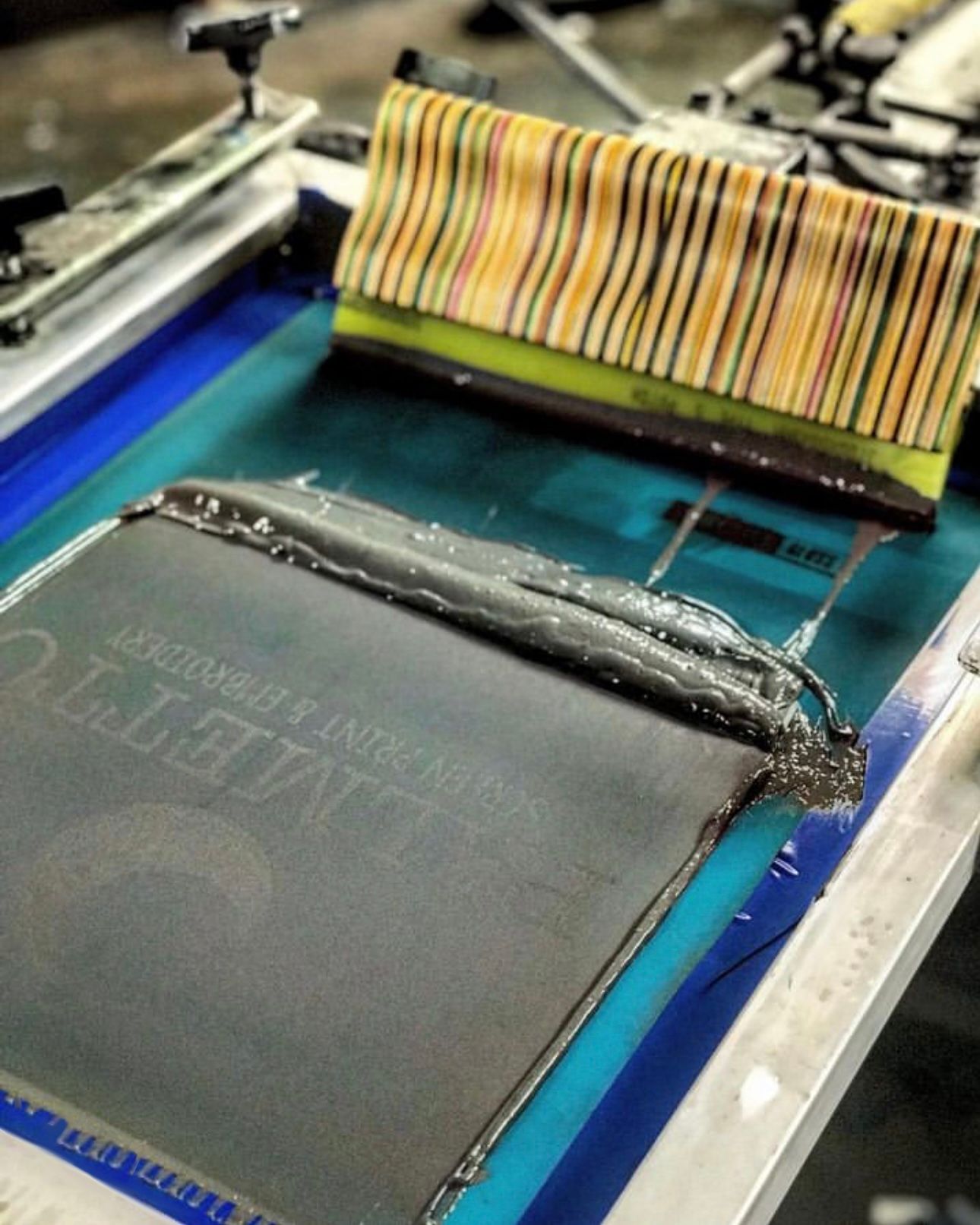 A screen printing machine is being used to print a book