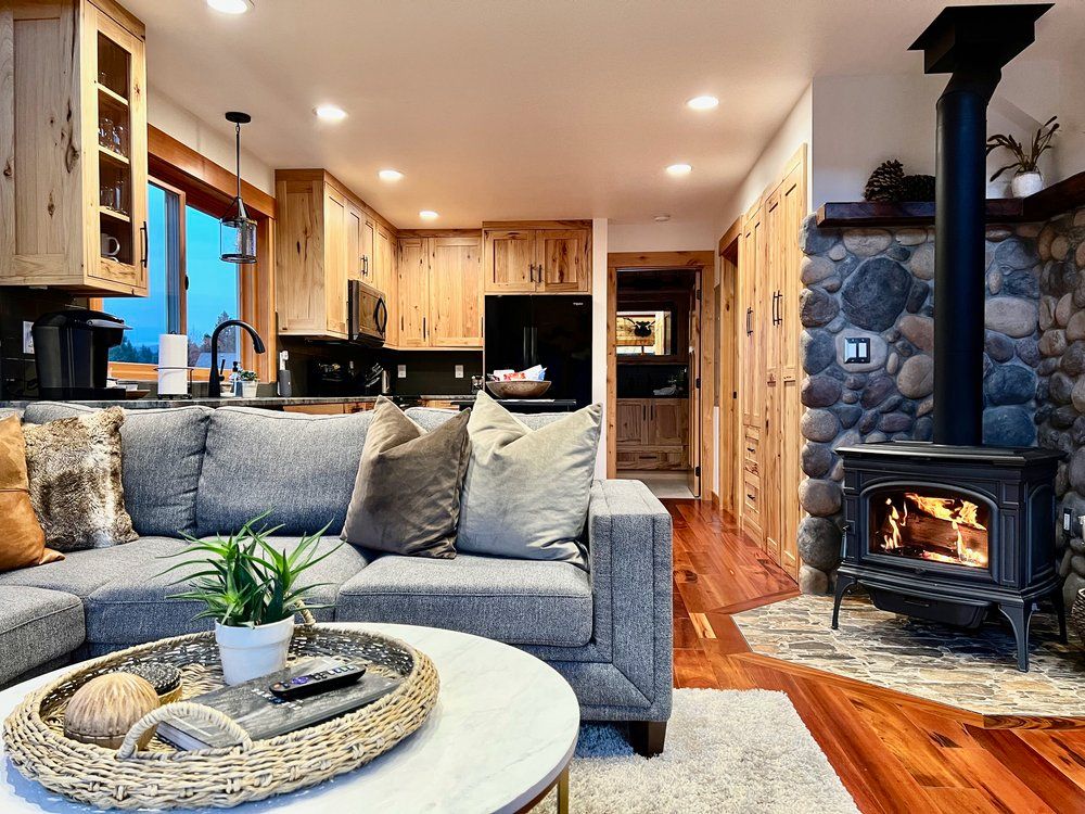 A living room with a couch, table, and fireplace.