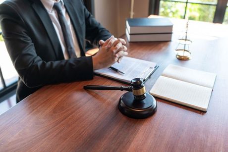 Justice concept an honorable judge sitting at the middle of the big wooden table 