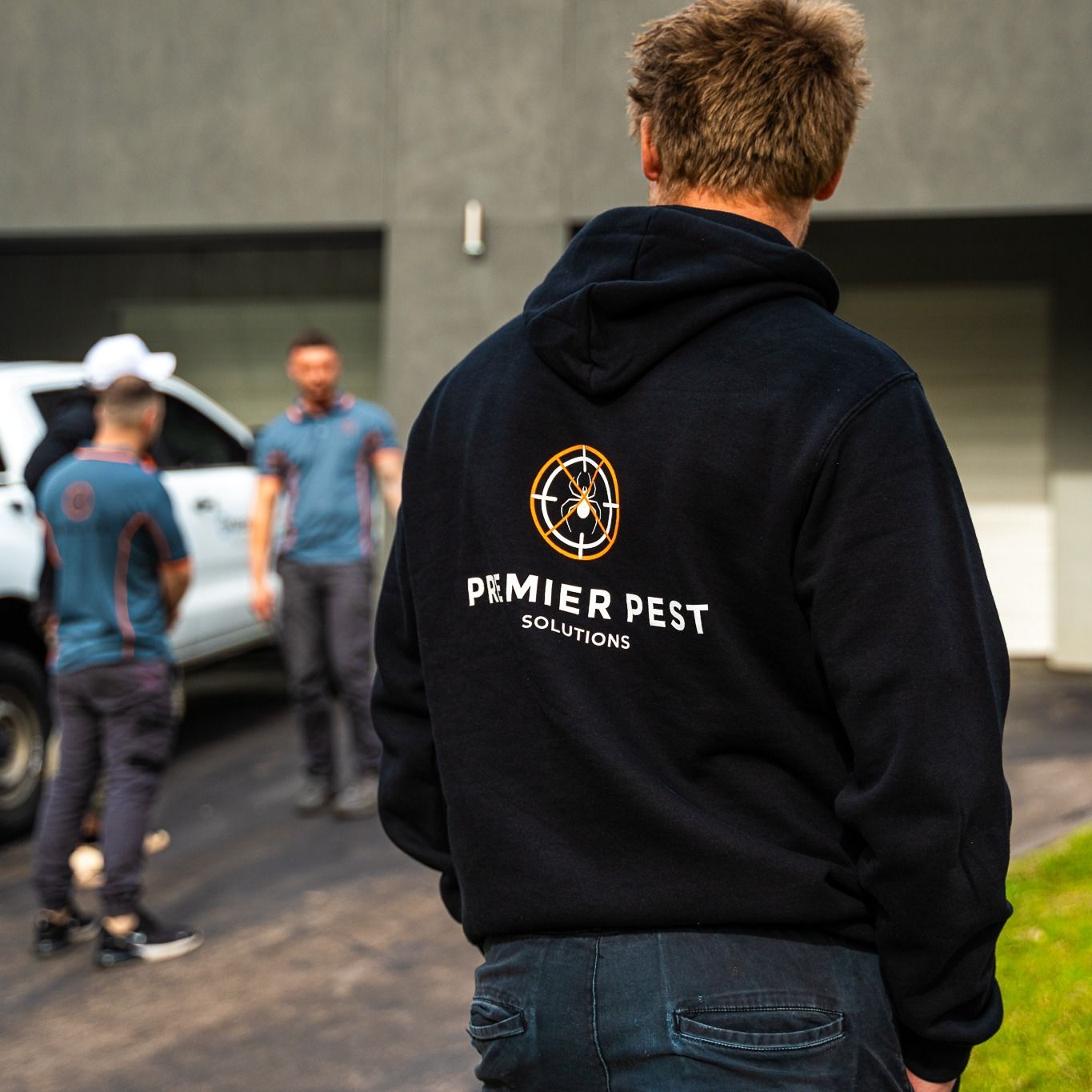 Man in Black Hoodie With Premier Pest Solutions Logo — Premier Pest Control Wollongong In Nowra, NSW