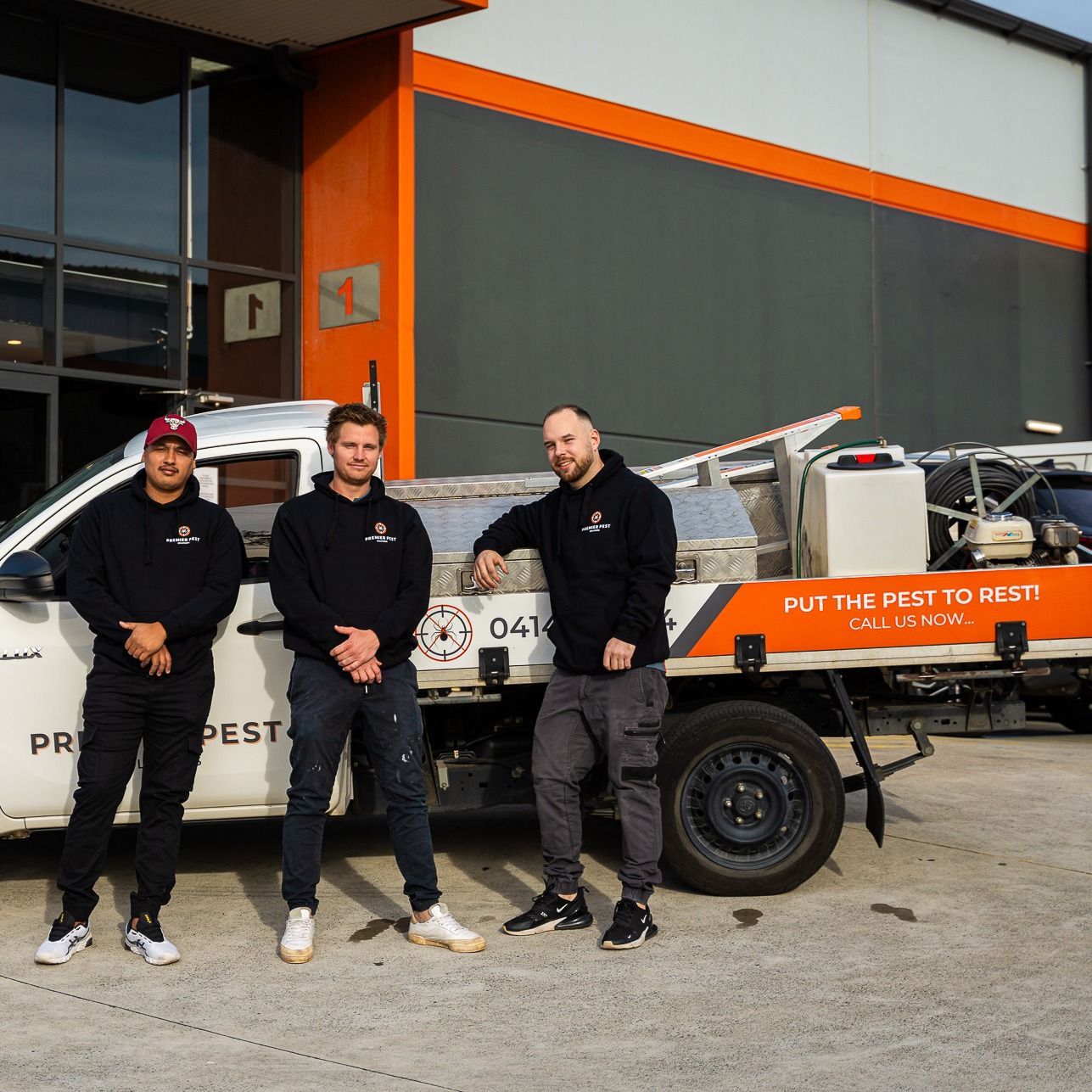 Three People Posing With a Pest Control Truck — Premier Pest Control Wollongong In Liverpool, NSW
