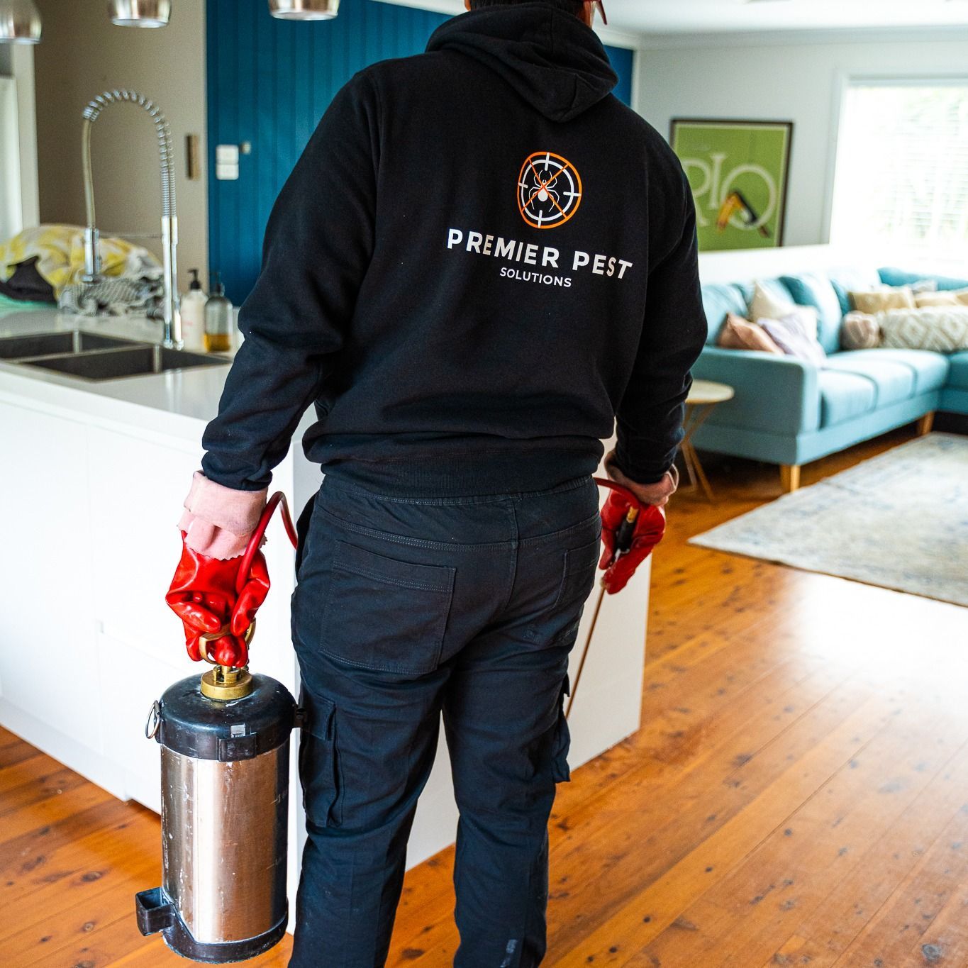 Pest Control Worker in Black Hoodie and Pants  — Premier Pest Control Wollongong In Parramatta, NSW