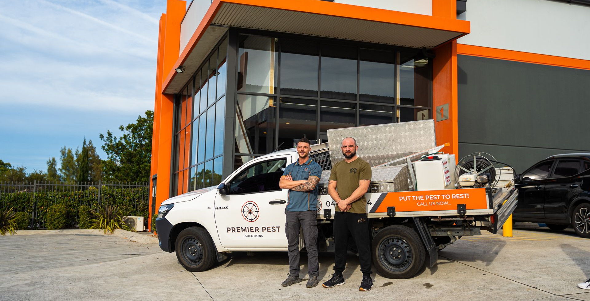 Two Men Stand Near a Truck in Front of Black Diamond Boxing — Premier Pest Control Wollongong In Sutherland Shire, NSW