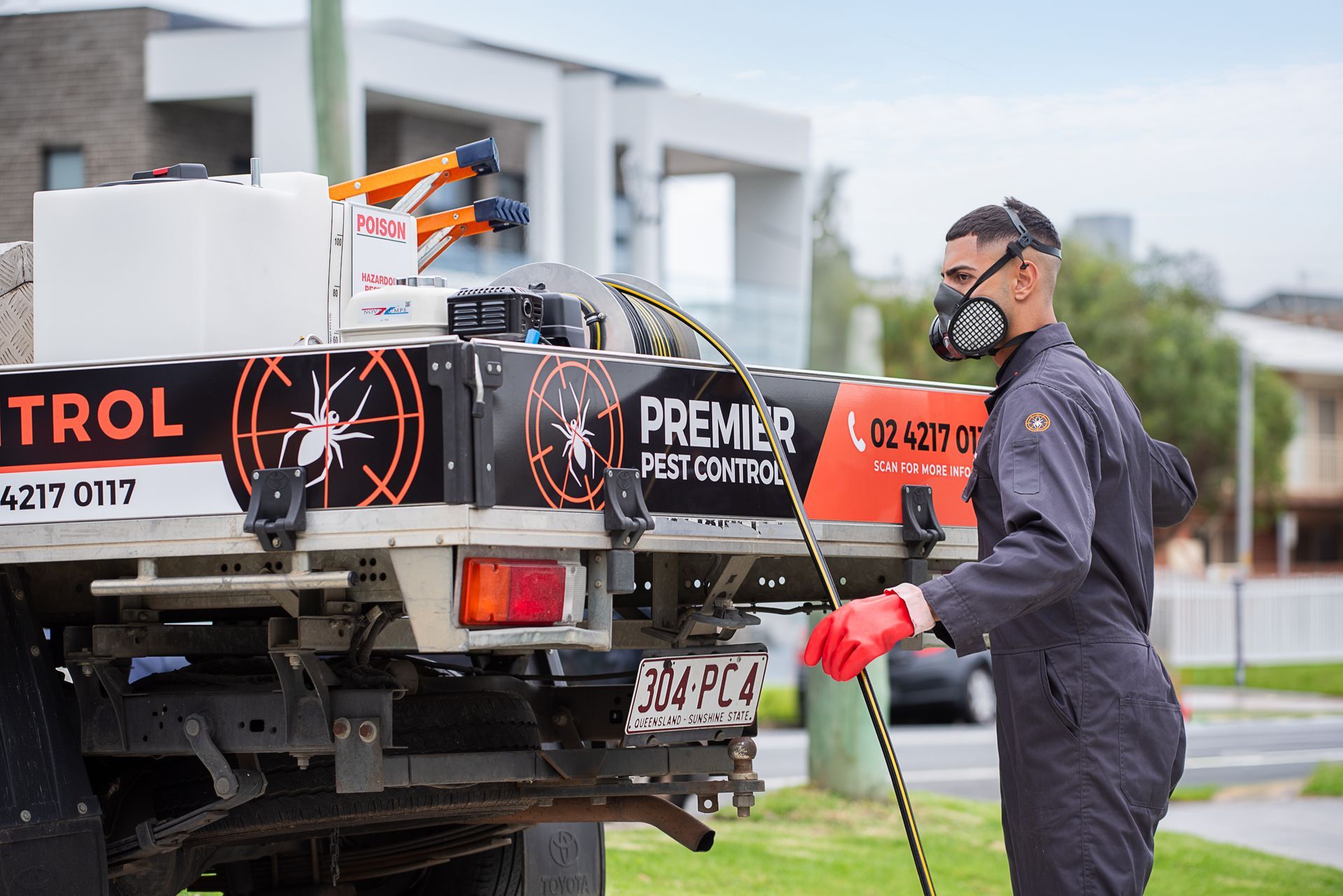 A Man Is Cleaning With A High Pressure Washer — Premier Pest Control Wollongong In Wollongong, NSW