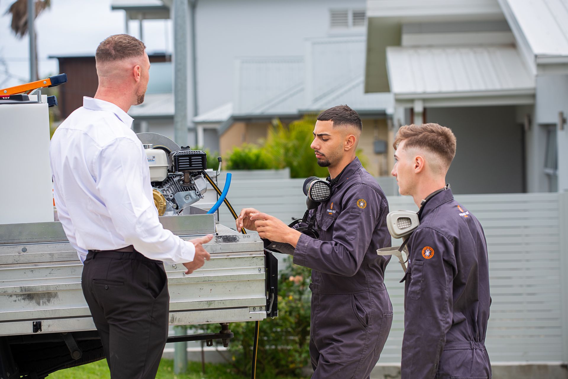 A Person Is Spraying A Wooden Floor With A Sprayer — Premier Pest Control Wollongong In Wollongong, NSW
