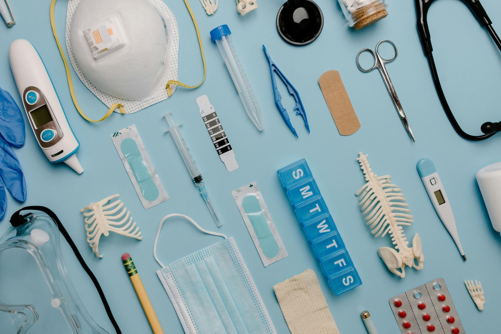 A blue table topped with a variety of medical supplies.