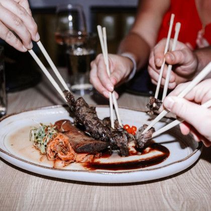 A plate of food with chopsticks sticking out of it