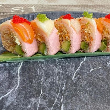 A close up of a plate of sushi on a table.