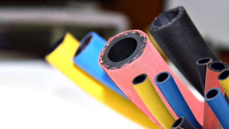 A Bunch Of Different Colored Pipes Are Sitting On A Table — NQPT In Garbutt, QLD
