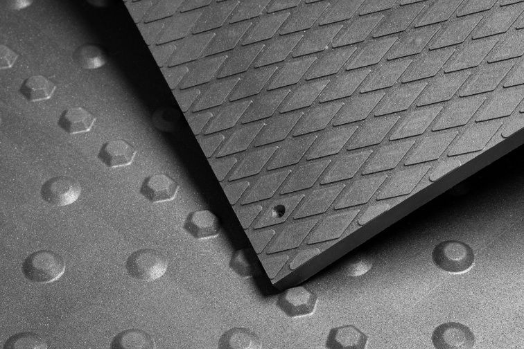 A Close Up Of A Black Mat With Holes In It — NQPT In Garbutt, QLD