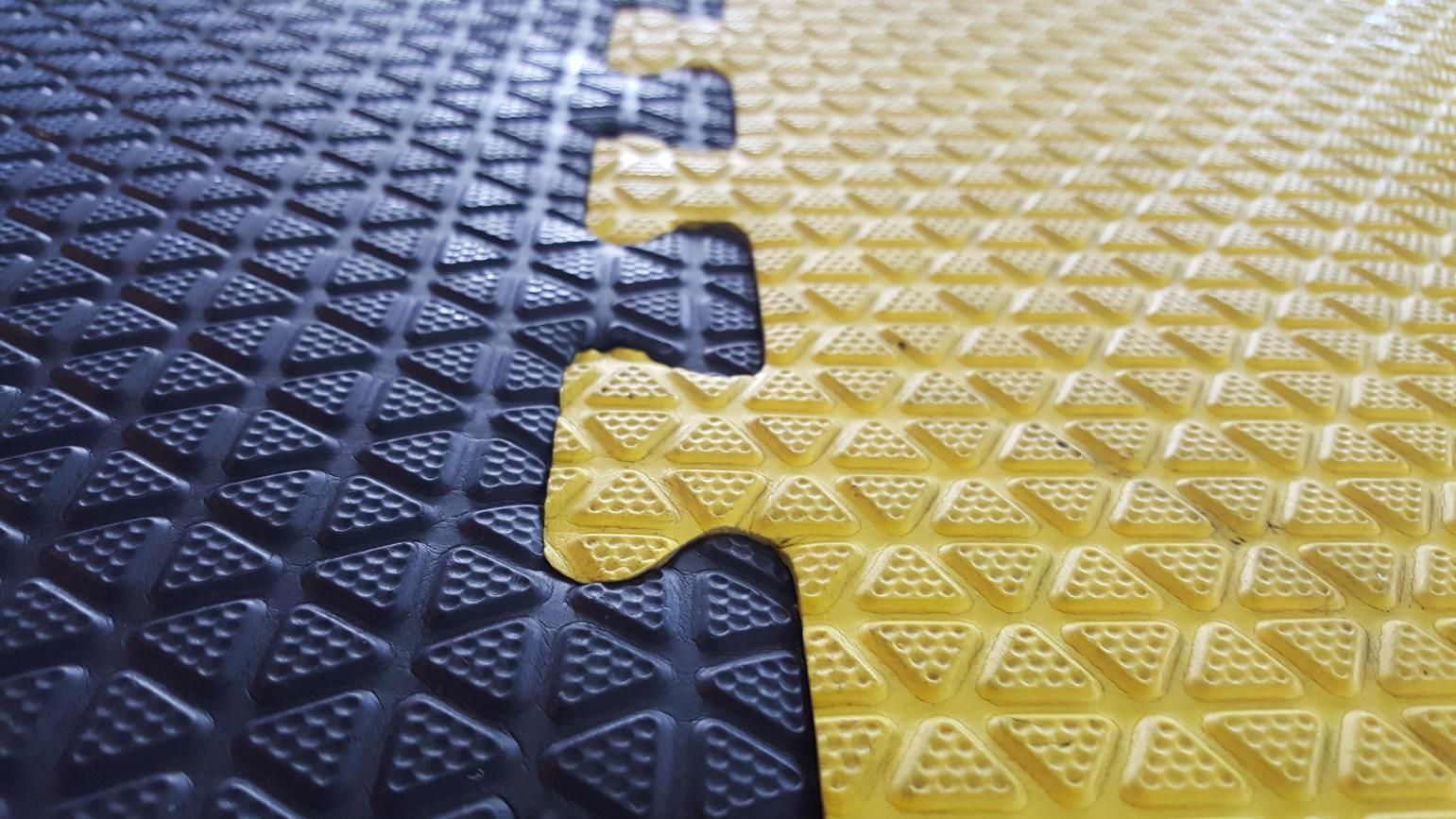 A Black And Yellow Puzzle Mat With A Yellow Piece Missing — NQPT In Garbutt, QLD