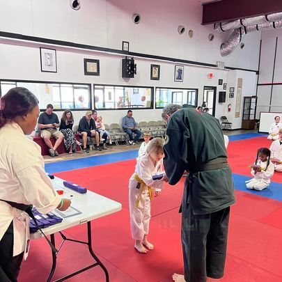 A group of people are practicing martial arts in a gym.