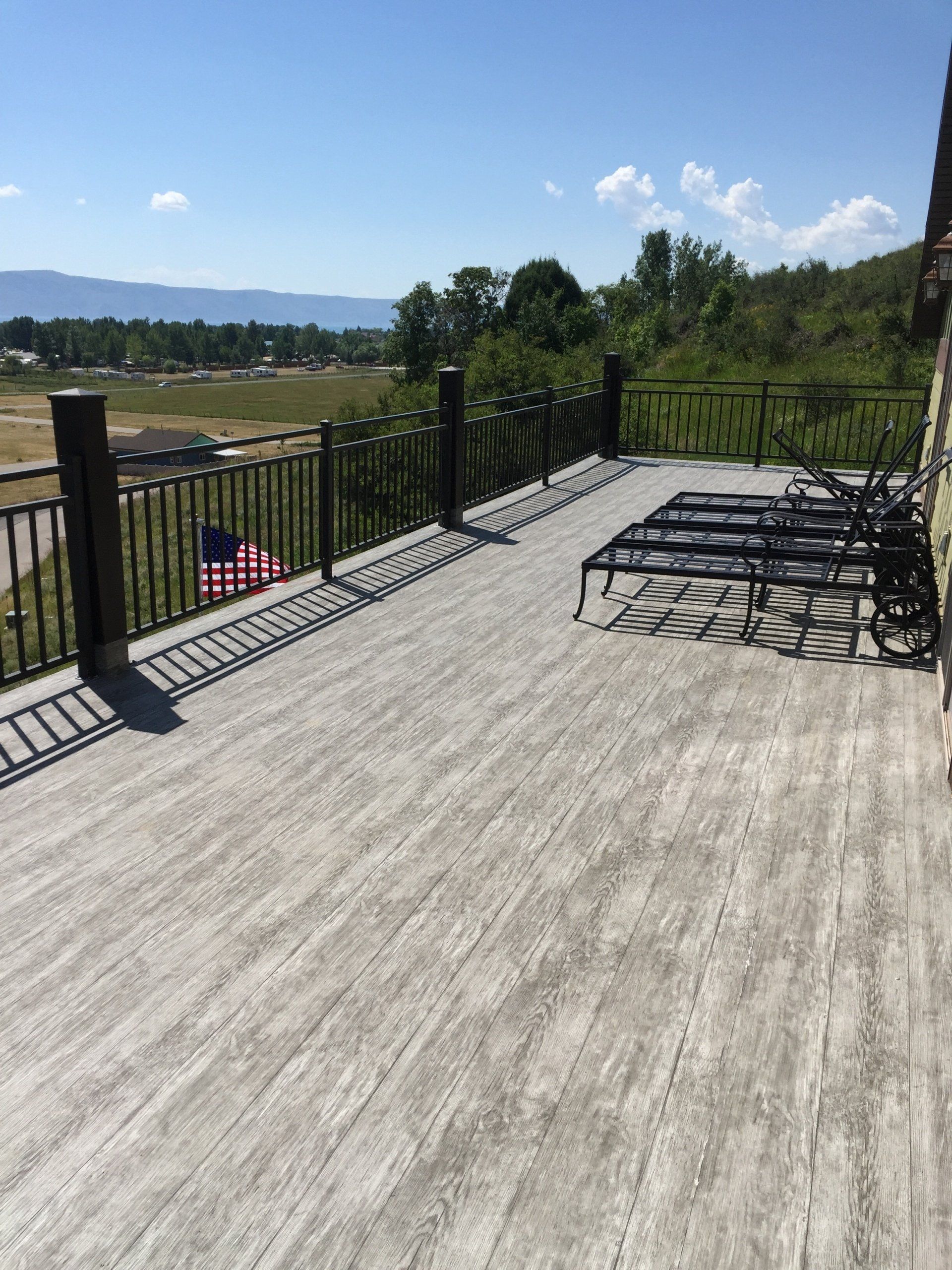 A deck with chairs and a flag on it