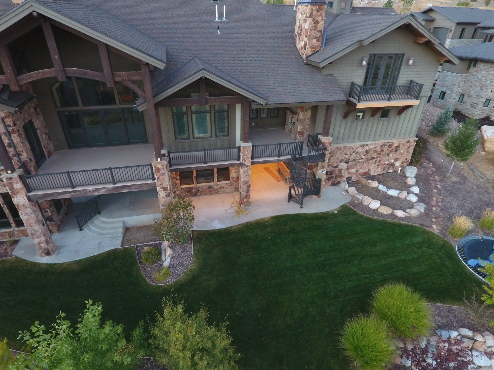 An aerial view of a large house with a large lawn in front of it
