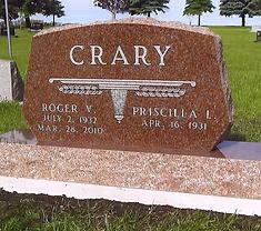 The front door of a house with a porch and plants in front of it.