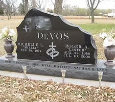 The front door of a house with a porch and plants in front of it.