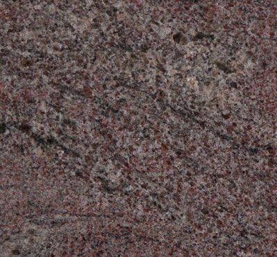 Red and gray granite stone surface with a coarse texture.
