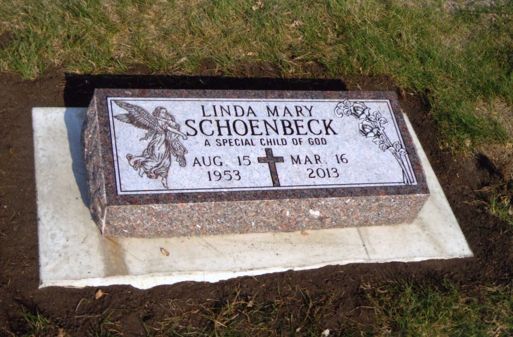 Headstone for Linda Mary Schoenbeck; granite marker with angel, cross, and birth/death dates.