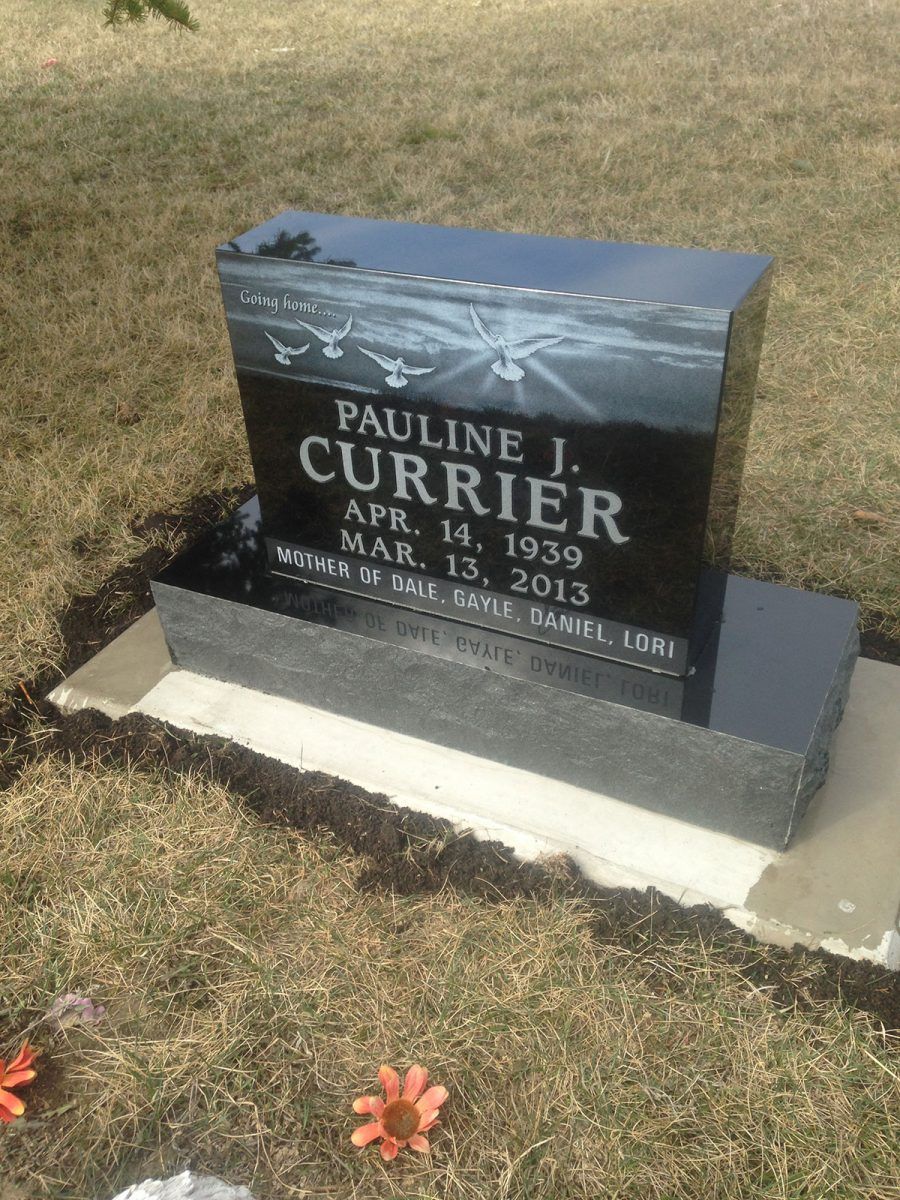 Black headstone with the name