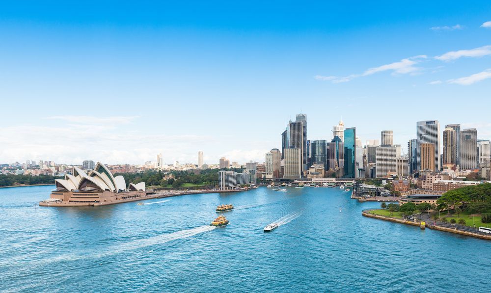 A Large Body Of Water With A City Skyline In The Background — Tradie Books Australia In Sydney, NSW
