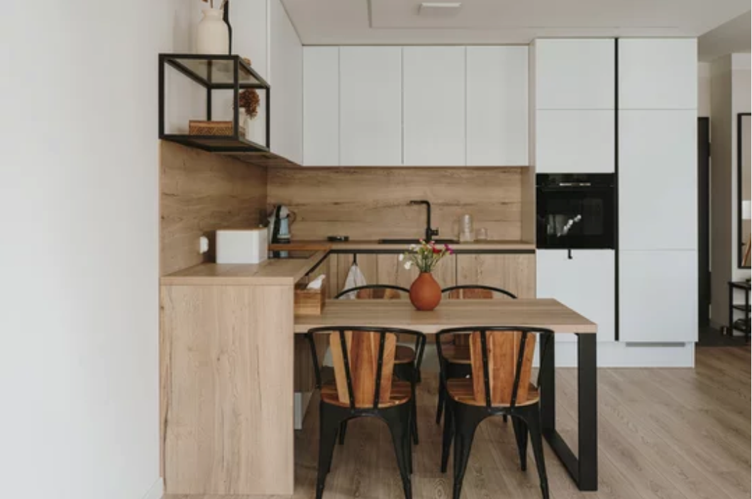A kitchen with a table and chairs in it.