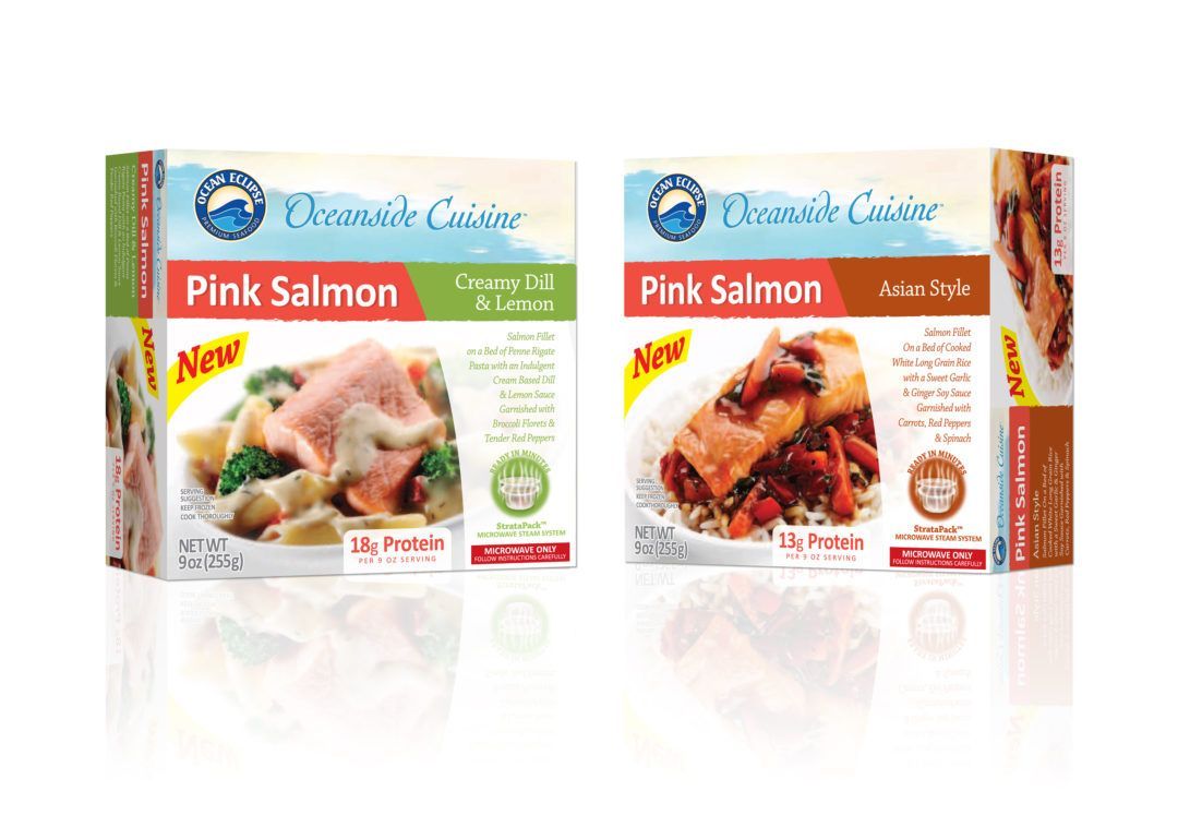 Two folding cartons of pink salmon are sitting next to each other on a table.