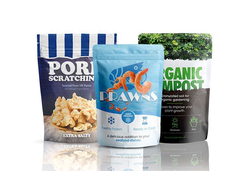 Three bags of food are sitting next to each other on a table.