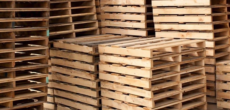 A pile of wooden pallets stacked on top of each other.