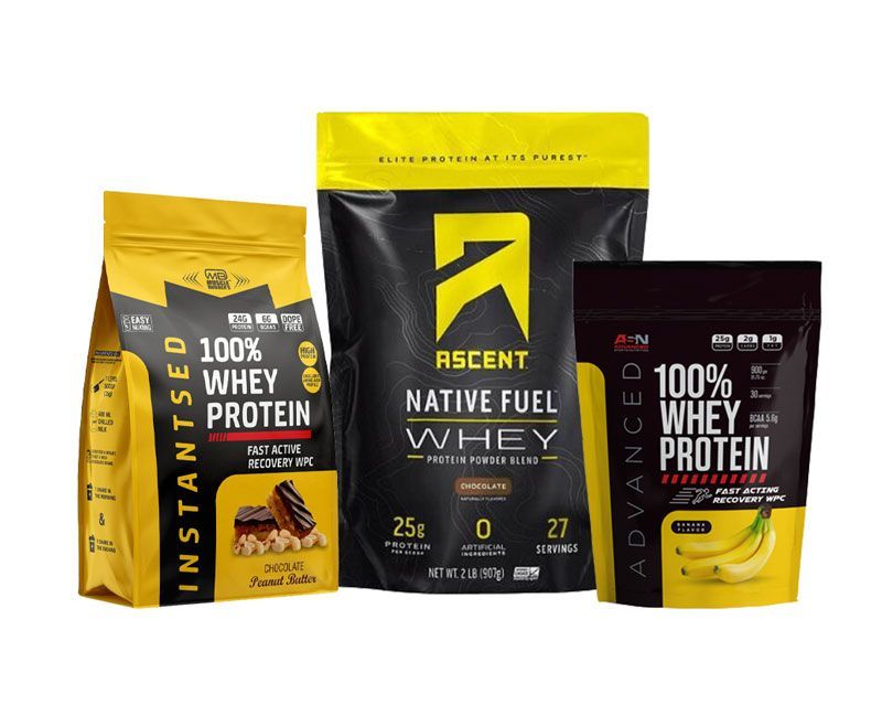 Three bags of whey protein are sitting next to each other on a white background.