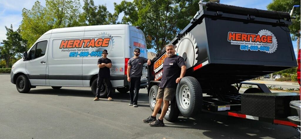Three men and a white van with black wheels and a trailer. All three vehicles are branded 