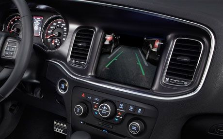 The dashboard of a dodge charger with a rear view camera.