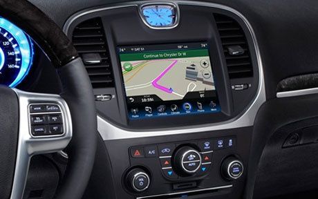 A car dashboard with a navigation system and a steering wheel