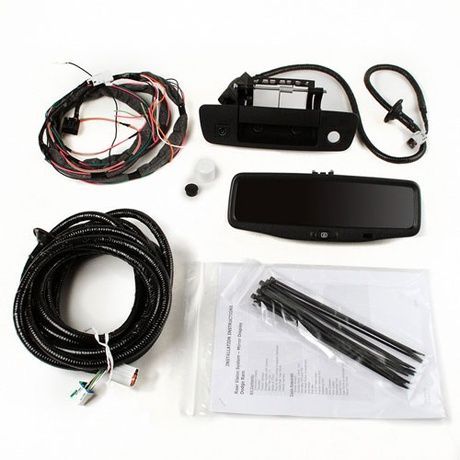 A bunch of wires and a rear view mirror are sitting on a table.