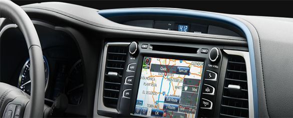 A car dashboard with a navigation system and a steering wheel