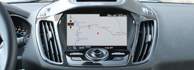 The dashboard of a car with a map on the screen.