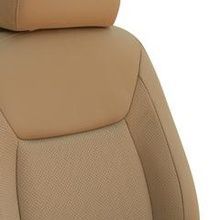 A close up of a tan car seat with a headrest on a white background.