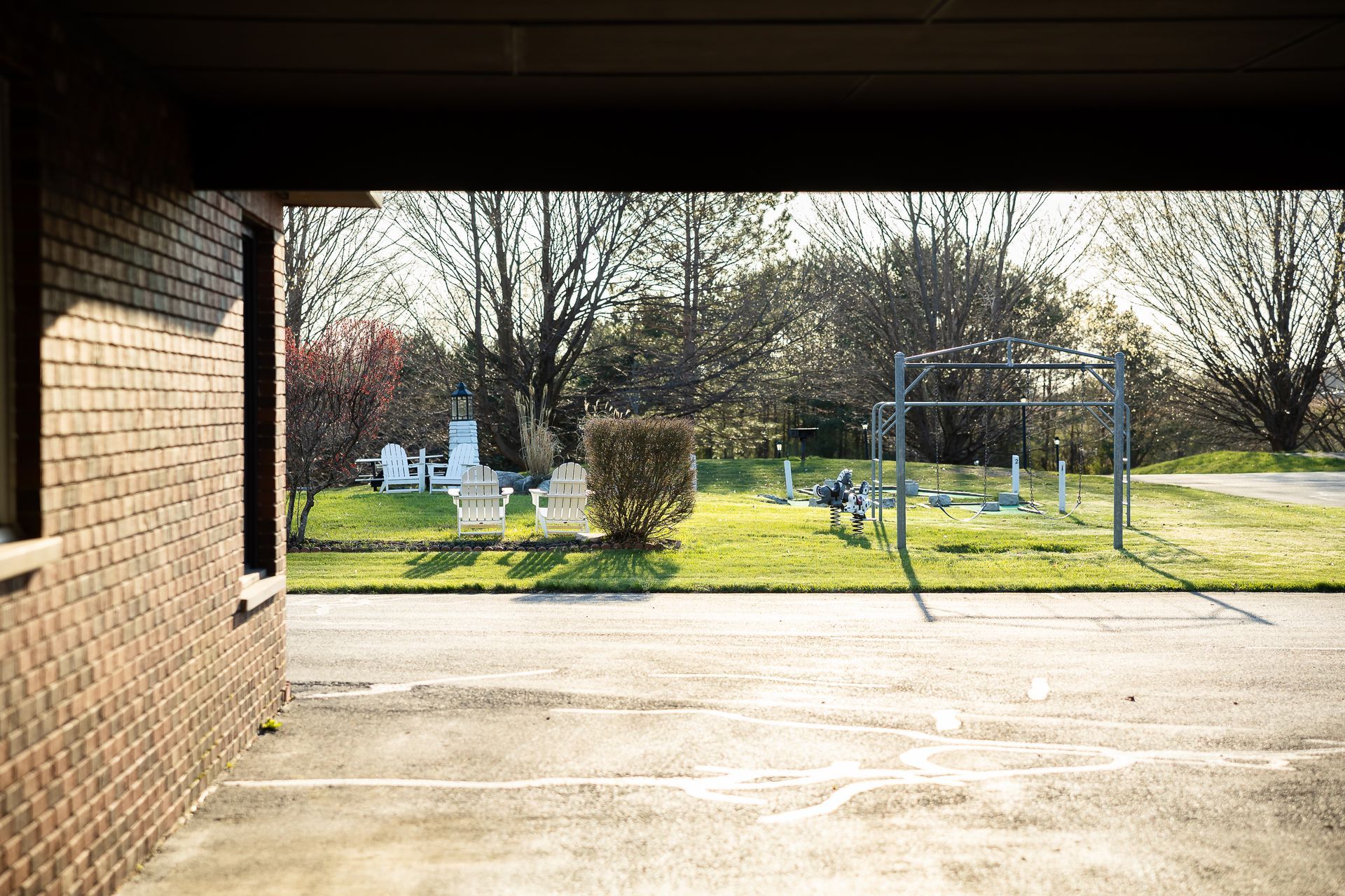 A view of a playground through a garage door.