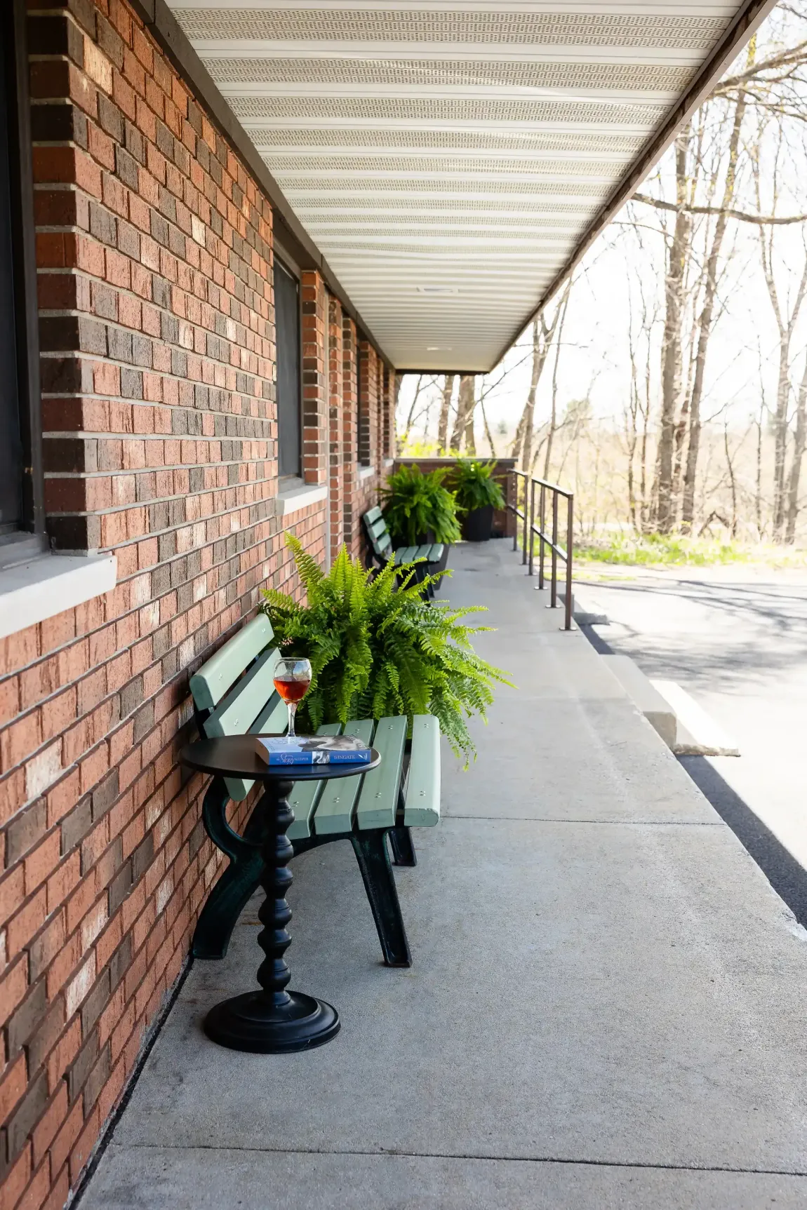 A brick building with a bench and plants on it