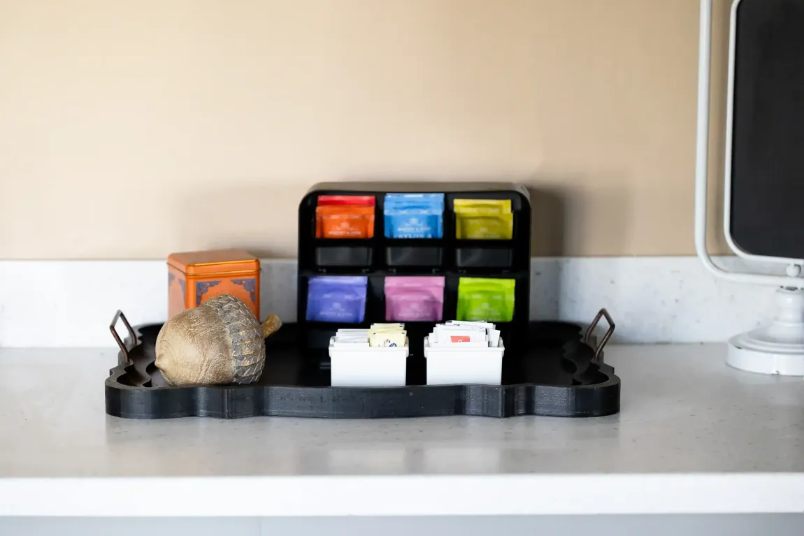 A tray with tea bags on it is on a counter.