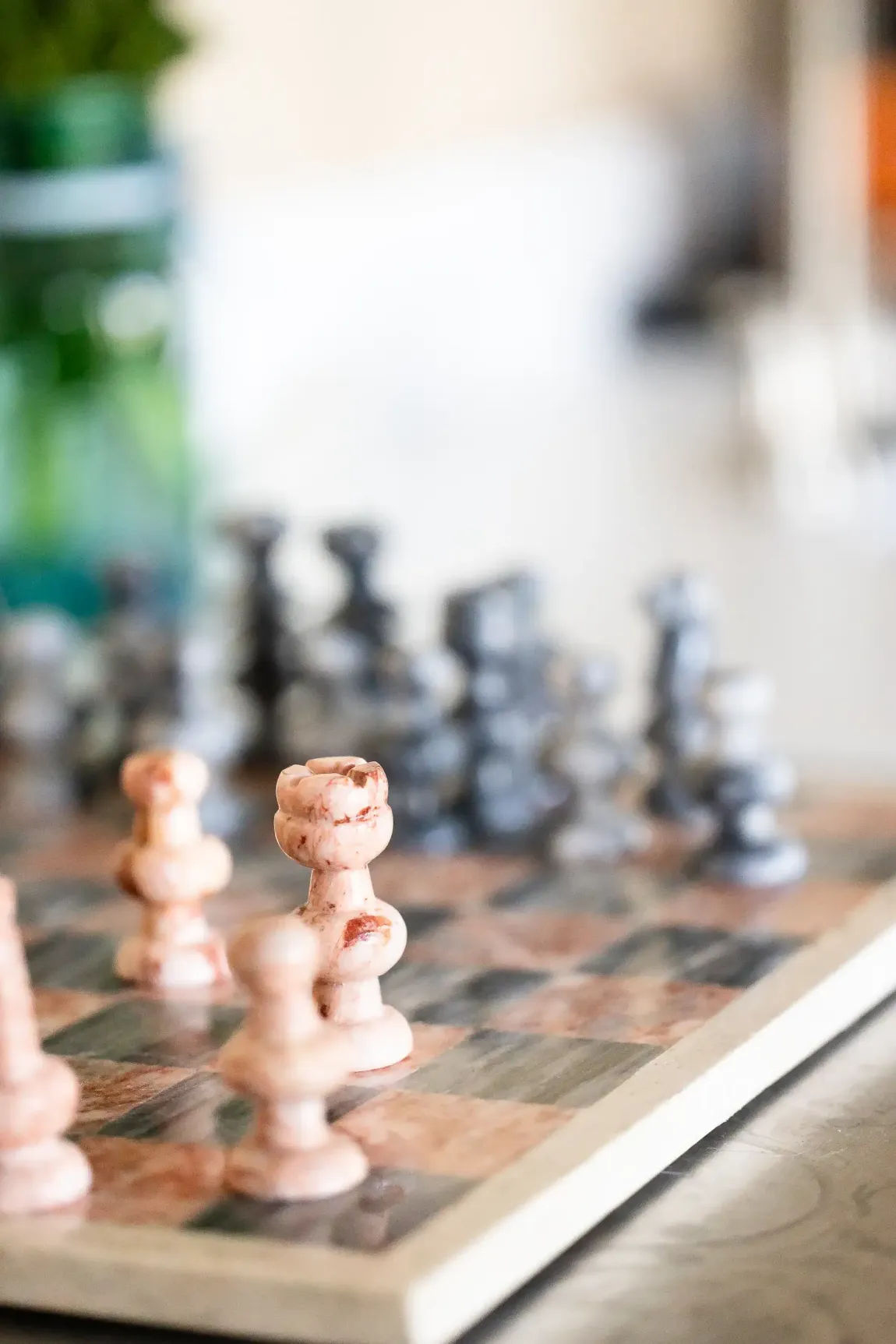 A close up of a chess board with chess pieces on it.