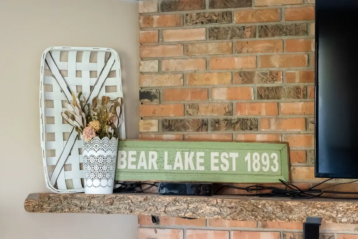 A fireplace with a sign that says bear lake est 1893 on it.