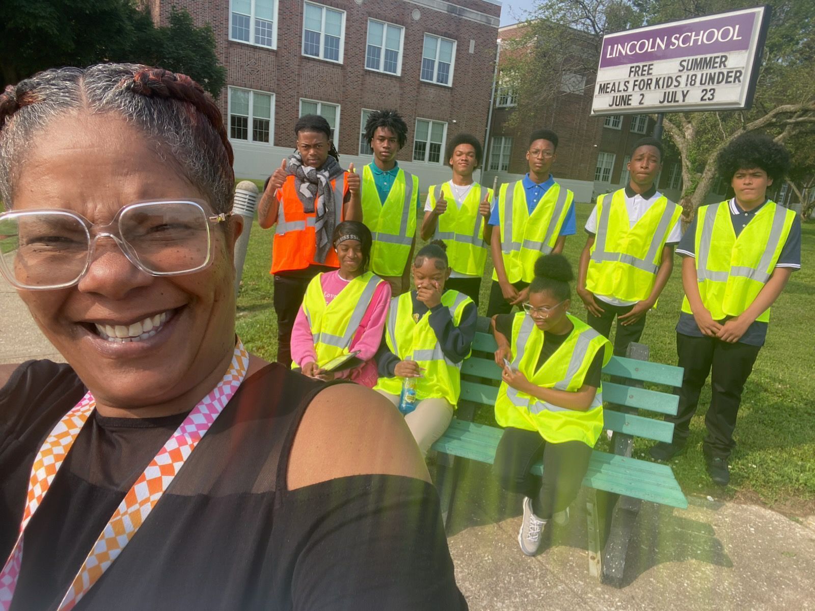 A group of people are walking in front of a varsity theater